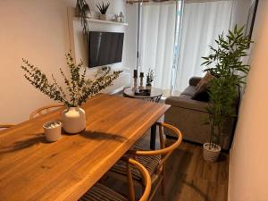 a living room with a wooden table and plants at Apartment in Lima JM in Lima