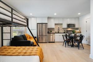 a bedroom with a bed and a kitchen with a table at Modern Downtown Apt Fast Wi-Fi & Parking in Austin +9 photos