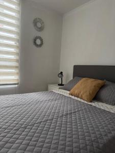 a bedroom with a bed and a clock on the wall at Apartment in Lima JM in Lima