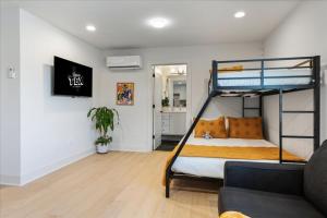 a bedroom with a bunk bed and a living room at Modern Downtown Apt Fast Wi-Fi & Parking in Austin