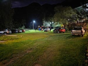a parking lot with cars parked in a park at night at Condominio La Curva in Churín