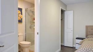 a bathroom with a bed and a shower and a toilet at Meet Cottage in Vancouver +26 photos