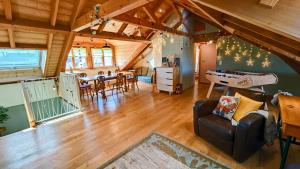 a living room with a couch and a dining room at Grand duplex familial 113 m - Jardin - Colmar Gare - Jusqu'à 8 pers in Colmar