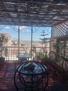 a patio with a table and chairs and a view at Esc 6 3 9 in Fez