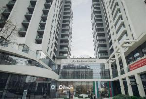 a large apartment building with a glass facade at Baku Sabah Apart in Baku