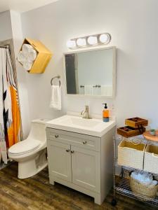 a bathroom with a white sink and a toilet at The Darmont Hotel and Suites in Darby +17 photos