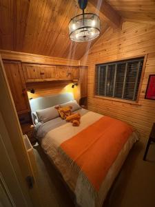 a bedroom with a teddy bear sitting on a bed at The Firkin Lodge in Whaplode
