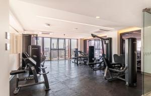 a gym with several treadmills and machines in a room at Kukun Reforma & Downtown in Mexico City