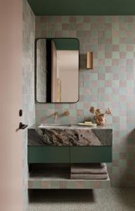 a bathroom with a marble sink and a mirror at Bon Bon Apt 1 - Papi in Orange