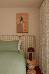a bedroom with a bed and a picture of a bird at Bon Bon Apt 1 - Papi in Orange