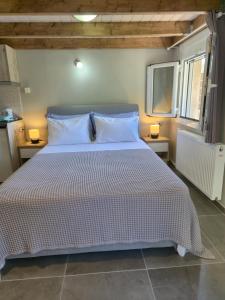 a bedroom with a large bed with two night stands at Sogno 1 in Parga