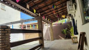 a patio with colorful kites hanging from a building at Funcional, cômoda e confortável in Camaçari