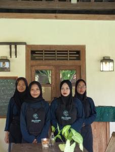 a group of women sitting at a table in a room at Blauwtuin Yogyakarta in Yogyakarta