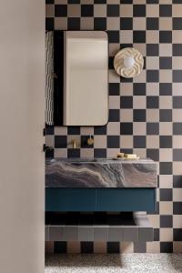 a bathroom with a sink and a mirror at Bon Bon Apt 5 - Tonka in Orange