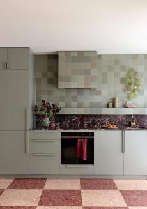 a kitchen with white cabinets and a black oven at Bon Bon Apt 4 - Roca in Orange