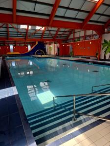 a large swimming pool with blue water at Loulex Deluxe in Jaywick Sands