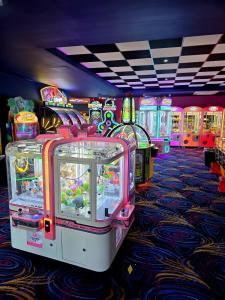 a row of arcade games in a gaming room at Loulex Deluxe in Jaywick Sands