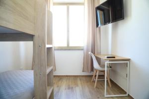 a small room with a desk and a bunk bed at Affittacamere Brezza Di Sirolo in Sirolo