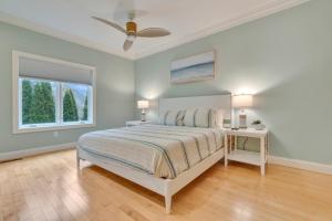 a white bedroom with a bed and a window at The Hill Dog Friendly Panoramic Ocean Views in York