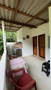 a bedroom with a bed and a desk in a room at Sítio Pereira in Paraty