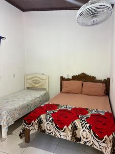 a bedroom with a large bed and a bedskirts at Sítio Pereira in Paraty