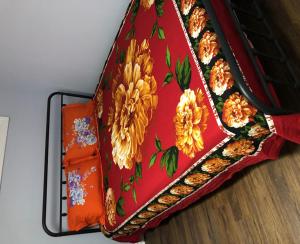 a red purse with yellow flowers on it at SHAY-BASEMENT-Holiday Home in Pickering