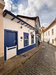 a blue and white building on the side of a street at Uai hostel in Ouro Preto