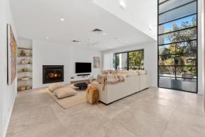 a living room with a couch and a fireplace at Luxe on North Point in Kingscliff
