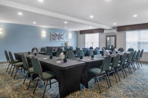 a conference room with long tables and chairs at Best Western Plus Grand-Sault Hotel & Suites in Grand Falls +48 photos
