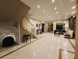a large living room with a fireplace and a staircase at Hotel Hernandarias in Santa Fe