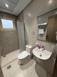a bathroom with a toilet and a sink at Retaj Al Noor Hotel, فندق ريتاج النور in Medina +21 photos