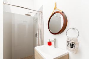 a bathroom with a white sink and a mirror at Hotel H4 El Paraíso in El Paraíso +31 photos