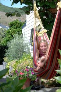 a young girl is sleeping in a hammock at Tasman Bay Backpackers in Nelson