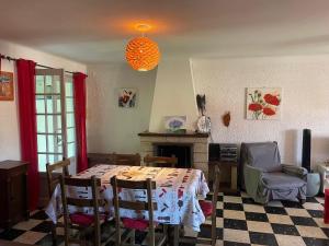 a dining room with a table and a fireplace at CHEZ NATH ET STEPH in Le Grau-dʼAgde