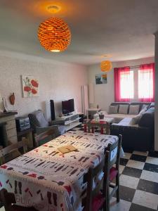 a living room with a table and a couch at CHEZ NATH ET STEPH in Le Grau-dʼAgde