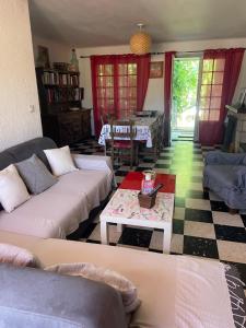 a living room with two couches and a table at CHEZ NATH ET STEPH in Le Grau-dʼAgde +15 photos