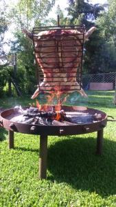 a fire pit sitting in the grass in a yard at La Posada del Sol in Torres