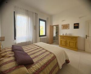 a bedroom with a large bed and a window at B&B Glicine in Civitanova Marche