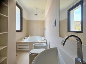 a bathroom with a tub and a toilet and a sink at B&B Glicine in Civitanova Marche +27 photos