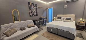 a bedroom with a bed and a couch in it at Girassol & Estética in Macapá