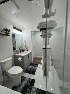 a bathroom with a toilet and a sink at Private Stylish Suite, Just Bring Your Bags in Edmonton