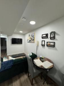 a living room with a couch and a table at Private Stylish Suite, Just Bring Your Bags in Edmonton