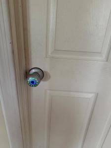 a door with a lock on a white door at Goodyear Cul-de-sac Room 5 in Goodyear