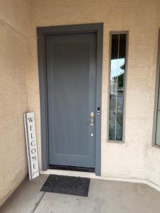a door to a house with a sign next to it at Goodyear Cul-de-sac Room 5 in Goodyear +2 photos