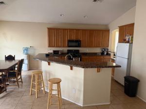 a kitchen with a counter top and a refrigerator at Goodyear Cul-de-sac Room 5 in Goodyear
