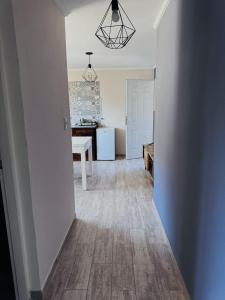 a hallway of a kitchen with a table and refrigerator at Brumas Patagónicas in El Chalten +8 photos