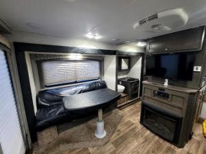 a living room in an rv with a couch and a tv at Gold Rush Historical Resort in Sonora