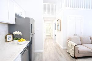 a kitchen with a refrigerator and a couch at Modern Yale Loft Best Location Parking in New Haven +31 photos
