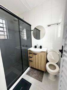 a bathroom with a toilet and a shower and a sink at CasaMara in Ribeirão Preto