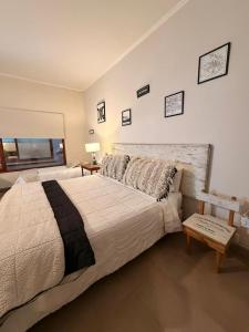 a bedroom with a large bed and a window at La Josefina Hotel Boutique in Olavarría
